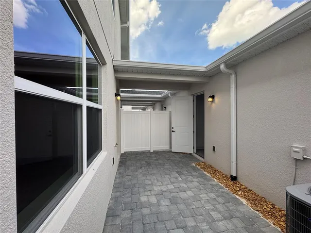 a view of an empty room and a window