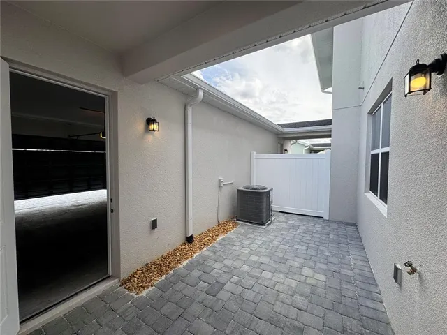 a view of swimming pool with outdoor seating and palm tree