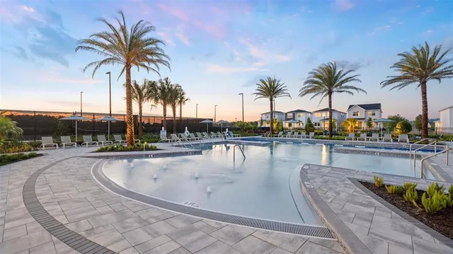 a swimming pool with outdoor seating and yard
