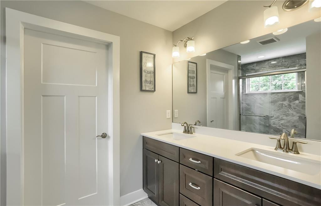 130 Vista Ridge Lane Valencia, PA 16059 - Photo 17 of 25 Relax in the spa-like bath with a tile shower with bench seating. A modern dual sink vanity and a walk-in closet complete the master bath.
