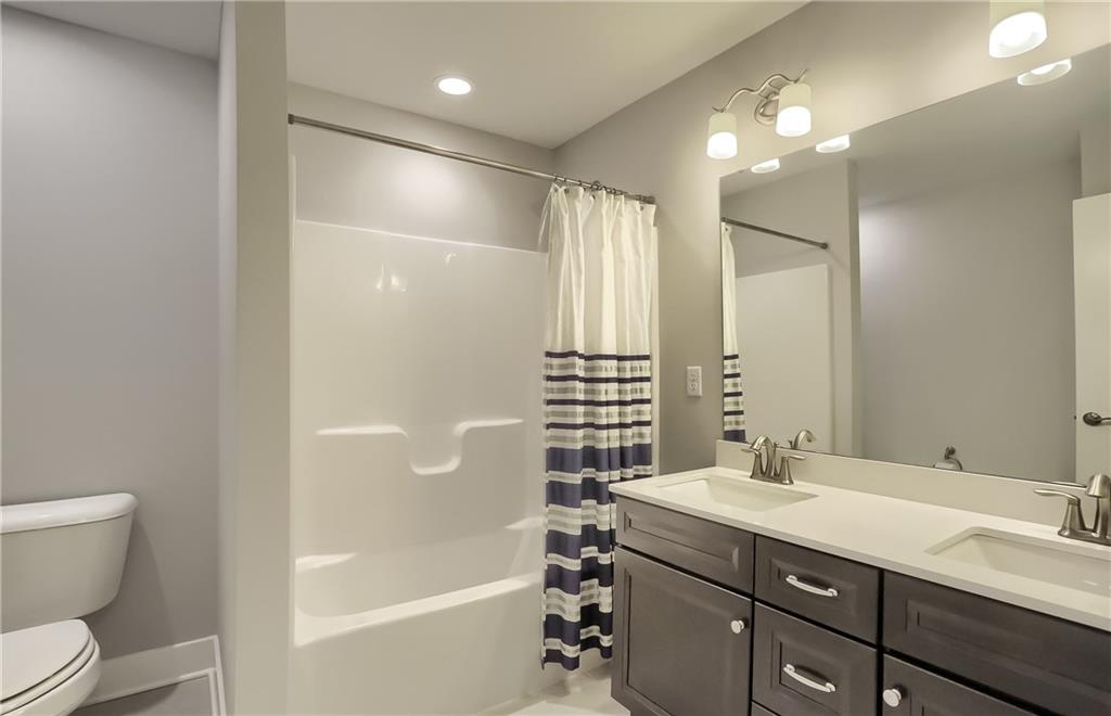 130 Vista Ridge Lane Valencia, PA 16059 - Photo 19 of 25 A shared hall bath has a modern dual sink vanity and tub/shower combo.