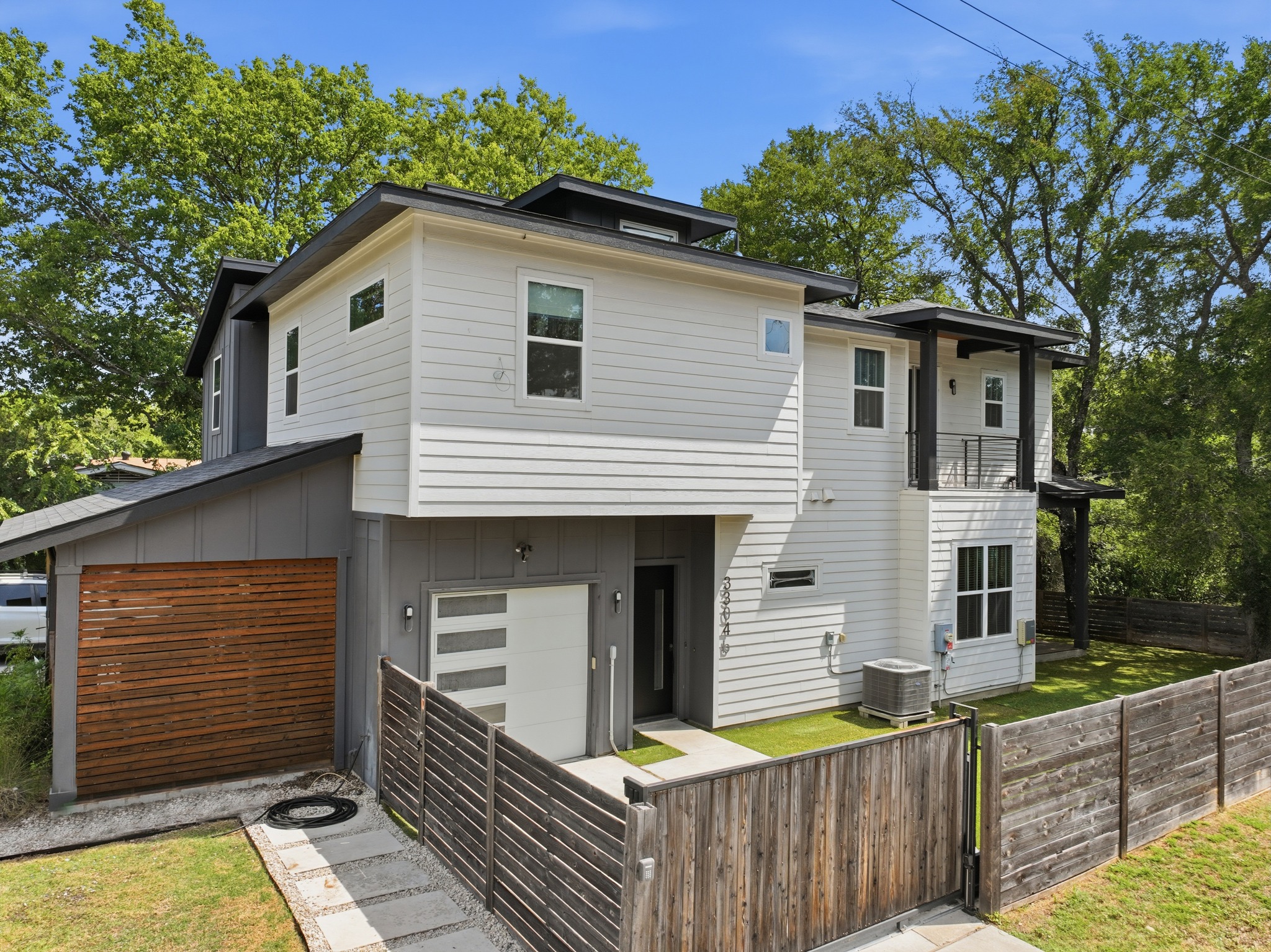 3304 East 17th Street, Unit B Austin, TX 78721 - Photo 34 of 35 Modern architecture with clean lines and contrasting siding creates exceptional curb appeal. This view shows electric gate closed