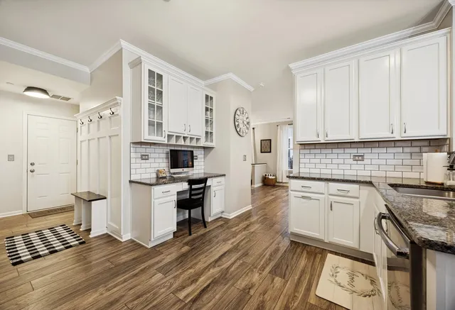 a view of a hallway with entryway wooden floor and front door