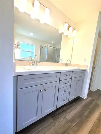 a bathroom with a granite countertop sink and a mirror