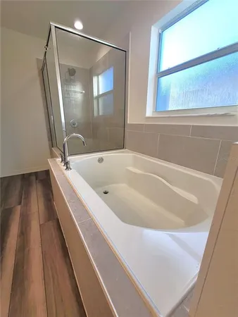 a bathroom with a tub and shower