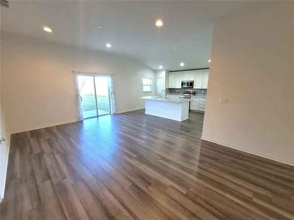 a view of kitchen with cabinets and wooden floor