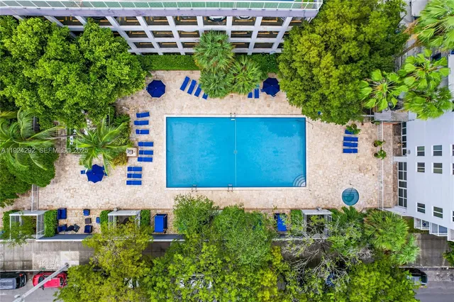 a view of swimming pool with outdoor seating and plants