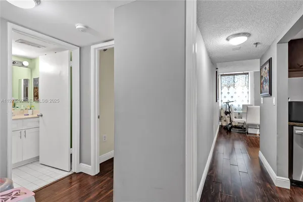 a view of a hallway with wooden floor