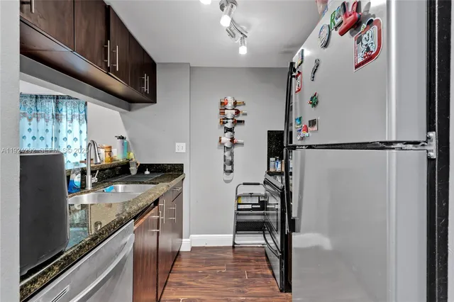 a kitchen with refrigerator and cabinets