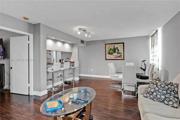 a living room with furniture and a book shelf
