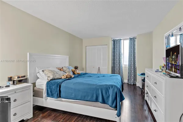 a bedroom with a bed and a dresser