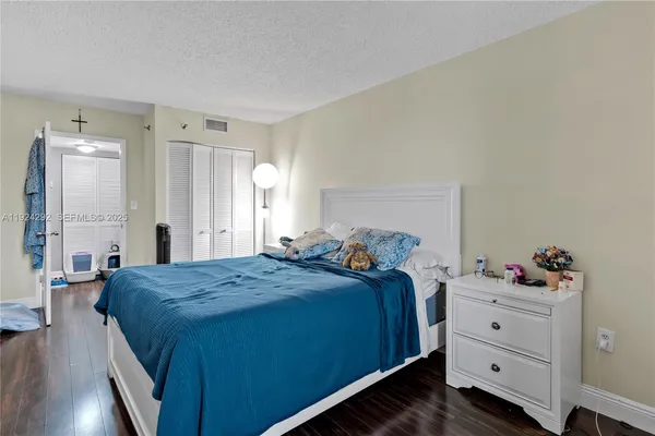 a bed room with a bed and a television