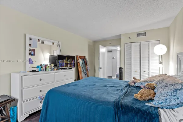 a bathroom with a sink a toilet a mirror and shower curtain