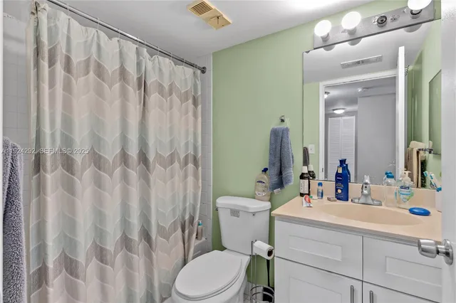 a bedroom with a bed and a wooden floor