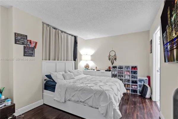 a bedroom with two bed and a lamp