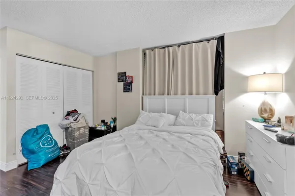 a bedroom with a bed and a tv in it