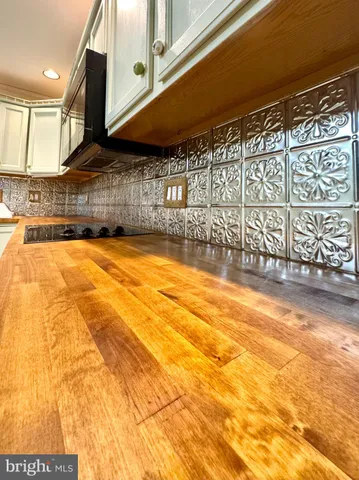 a kitchen with granite countertop white cabinets and stainless steel appliances