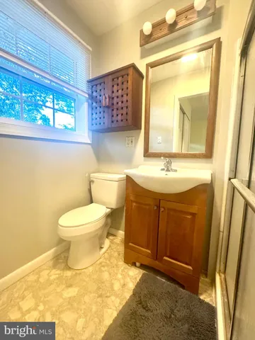 a living room with furniture and a dresser