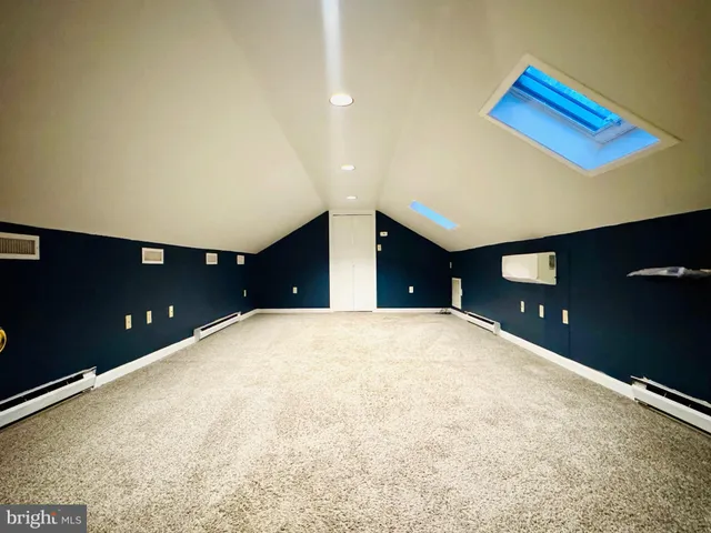 a front view of a house with a garden and plants