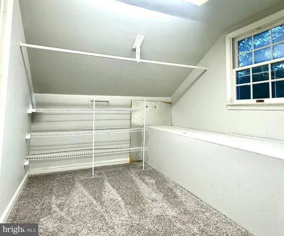 a view of a patio with a table and chairs next to a yard