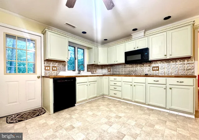 a kitchen with stainless steel appliances granite countertop a stove sink and cabinets