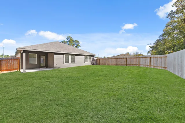 a kitchen with stainless steel appliances granite countertop a stove top oven a sink dishwasher and a refrigerator with wooden floor