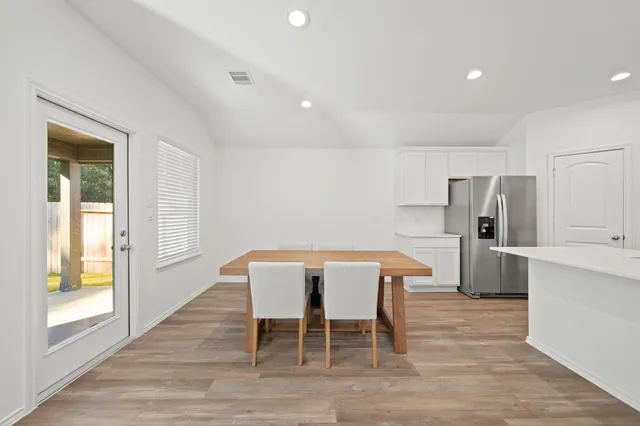 a view of a dining room with furniture and window