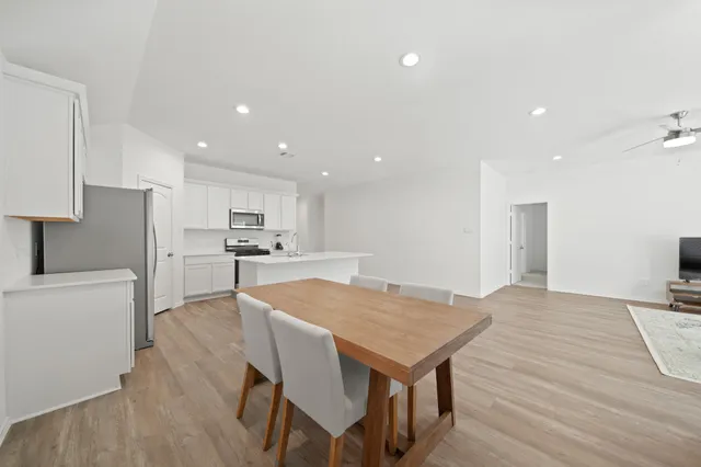 a kitchen with a table and chairs in it