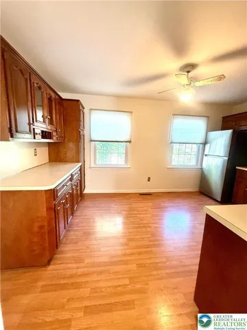 a kitchen with stainless steel appliances granite countertop a sink a stove top oven a counter space and cabinets