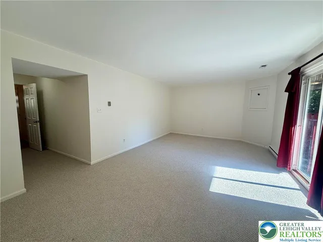 an empty room with a projector and closet