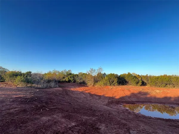 a view of mountain with sunset in background