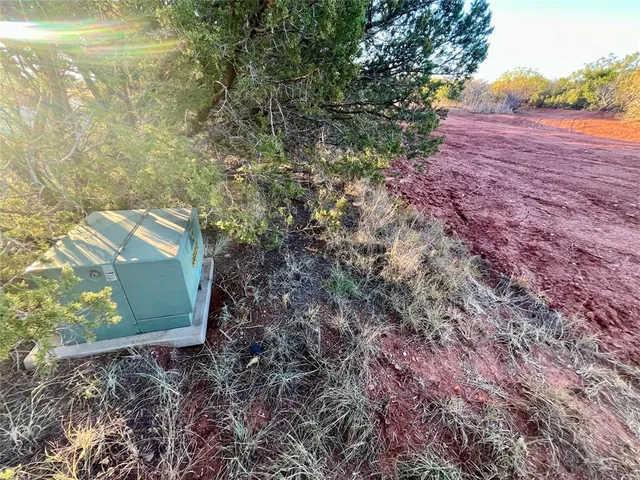 a view of a lake with trees in the background