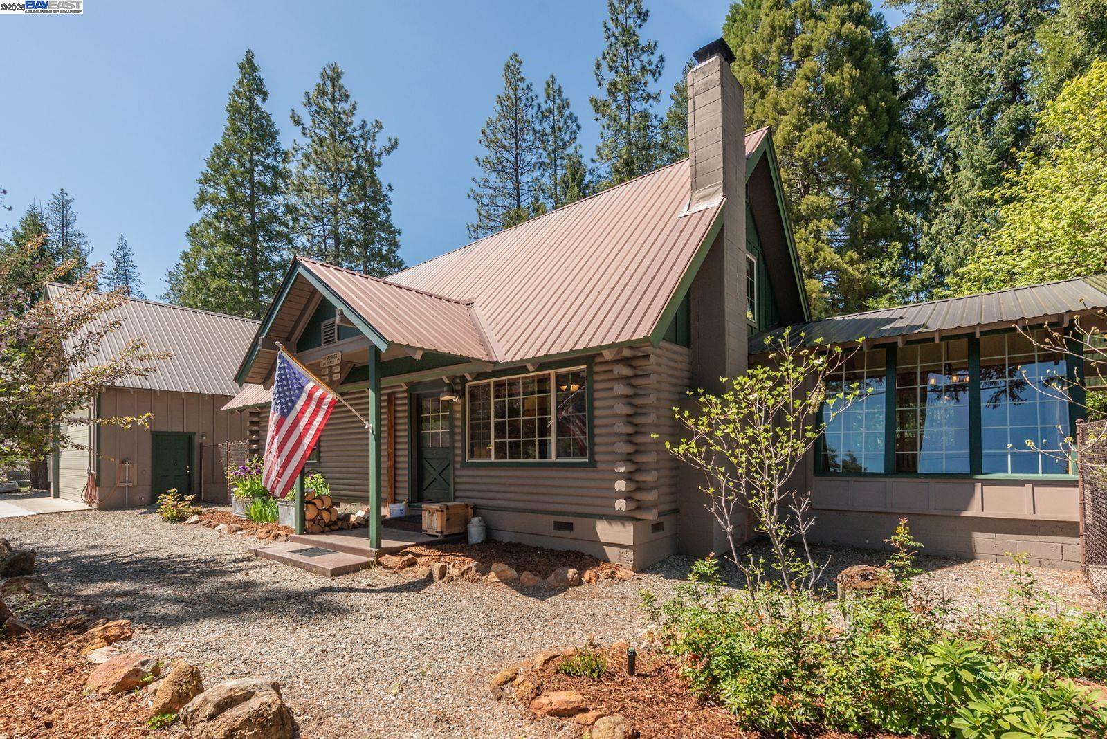 a backyard of a house with wooden fence and trees