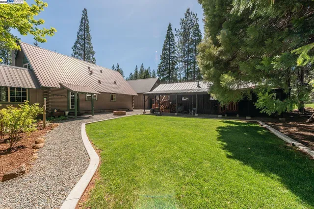 a swimming pool with outdoor seating and yard