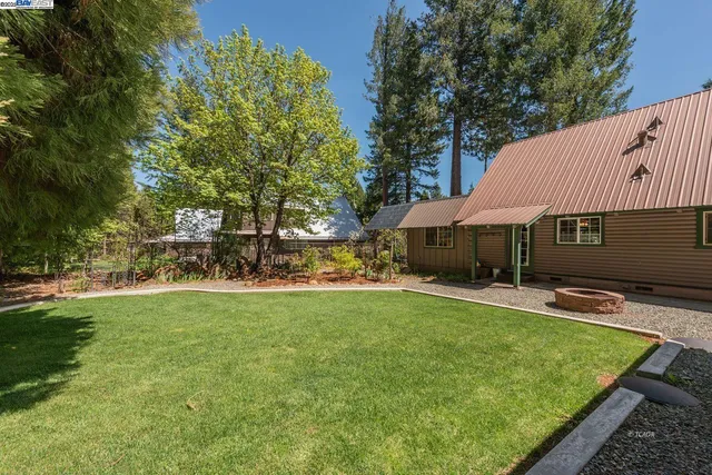 a view of a house with swimming pool and sitting area