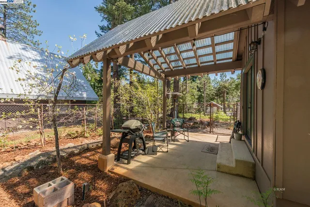 a view of a porch with chairs and backyard