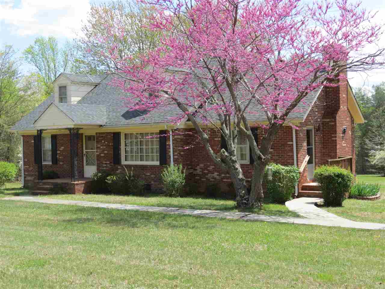 6280 Courthouse Road Louisa, VA 23093 - Photo 1 of 43 a front view of a house with a yard and garage