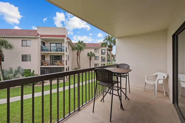 a view of a chair and tables in the balcony