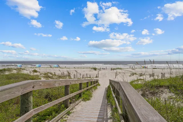 a living room with patio furniture and a large window