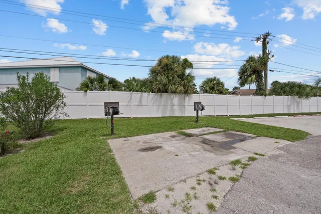 a view of a patio with a table and chairs under an umbrella