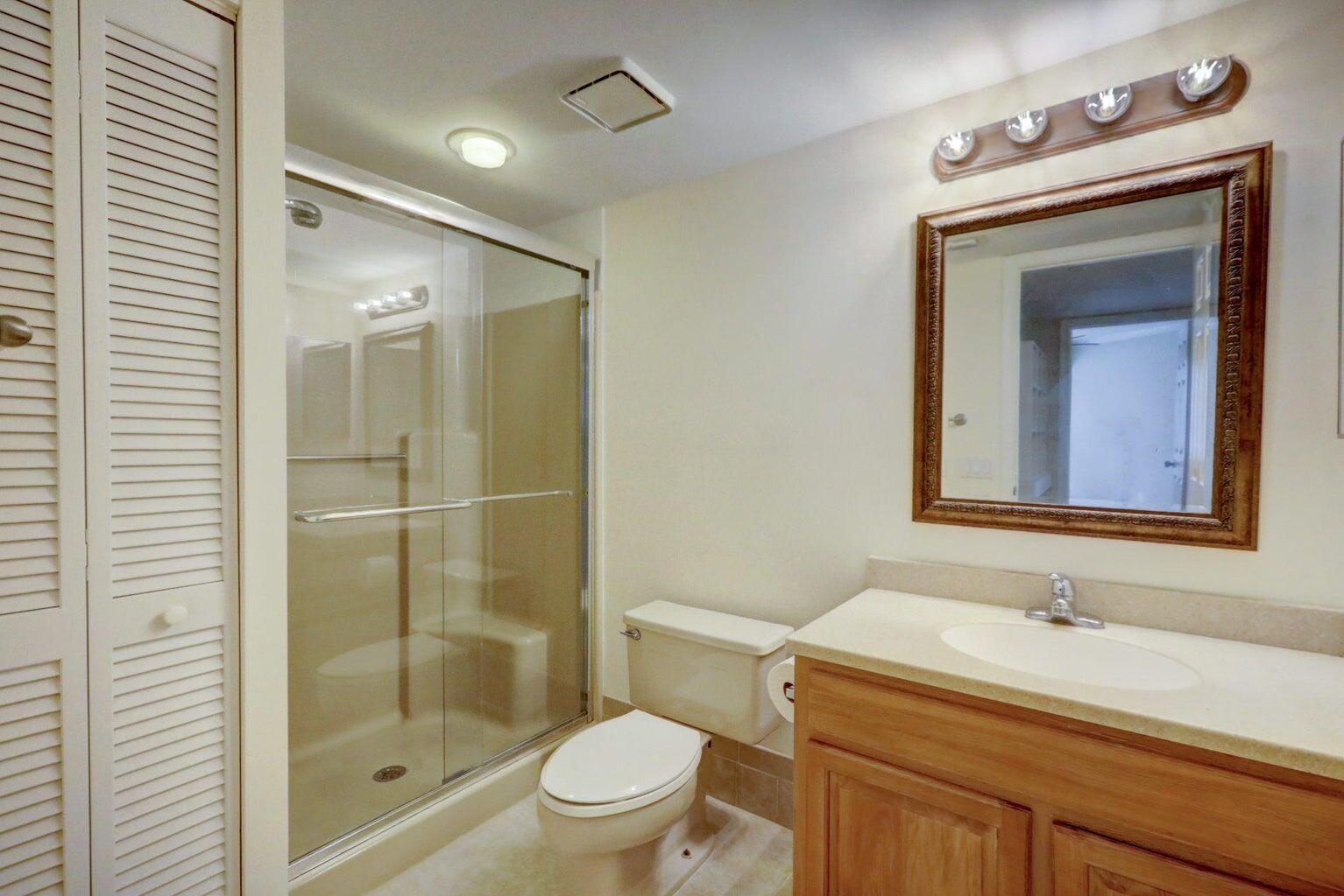 4356 Hazel Avenue, Unit C Palm Beach Gardens, FL 33410 - Photo 15 of 16 a bathroom with a sink a toilet and shower