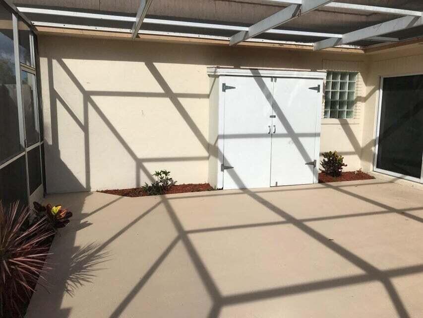 4356 Hazel Avenue, Unit C Palm Beach Gardens, FL 33410 - Photo 3 of 16 a view of a room with wooden floor and windows