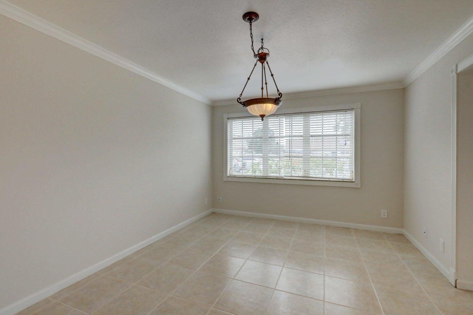 4356 Hazel Avenue, Unit C Palm Beach Gardens, FL 33410 - Photo 8 of 16 a view of a room with windows and chandelier
