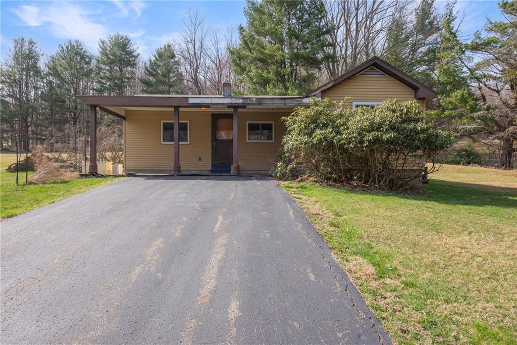 225 Pine Slopes Road Acme, PA 15610 - Photo 1 of 24 a front view of a house with a yard and garage