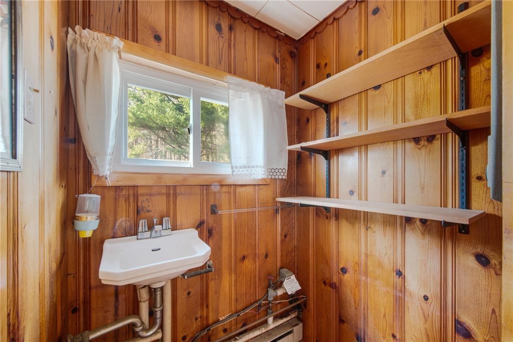 225 Pine Slopes Road Acme, PA 15610 - Photo 14 of 24 a bathroom with a sink a toilet and a window