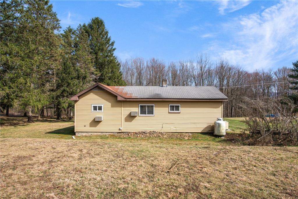 225 Pine Slopes Road Acme, PA 15610 - Photo 8 of 24 a view of house with yard and trees in the background