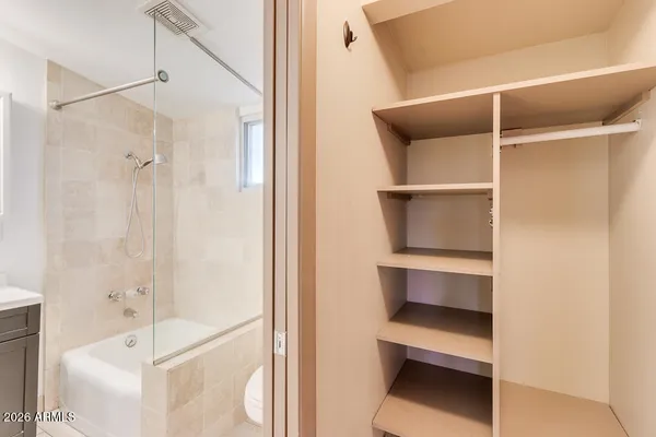 an empty room with chandelier fan