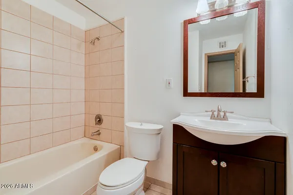 an empty room with ceiling fan and window