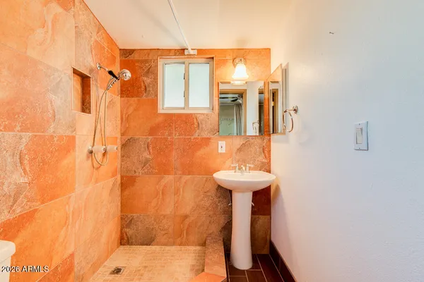 a patio with a table and chairs under an umbrella