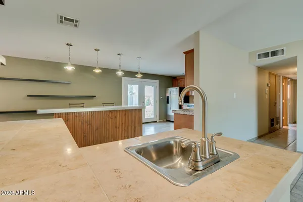a kitchen with stainless steel appliances kitchen island hardwood floor and wooden cabinets